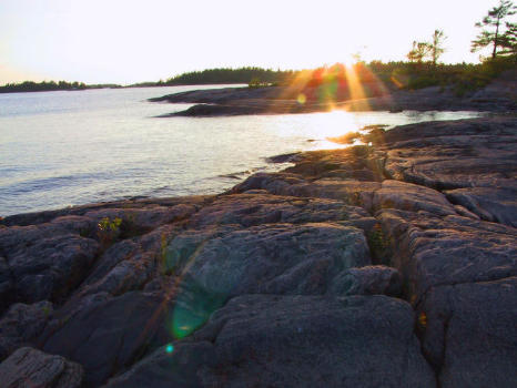 luminous sunrays along waterside