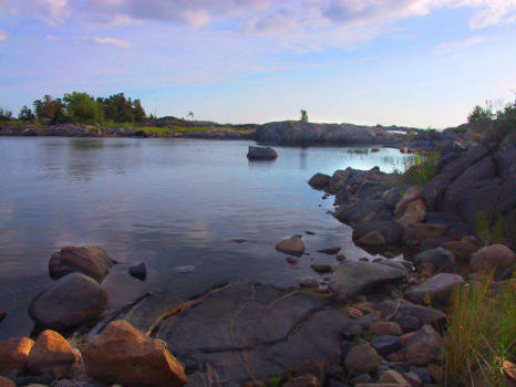 Waterside rocks light by the low sun